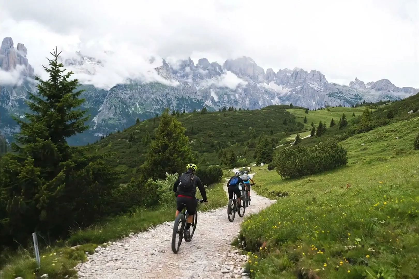 E-bike riders on the Canfedin trail with the Brenta behind