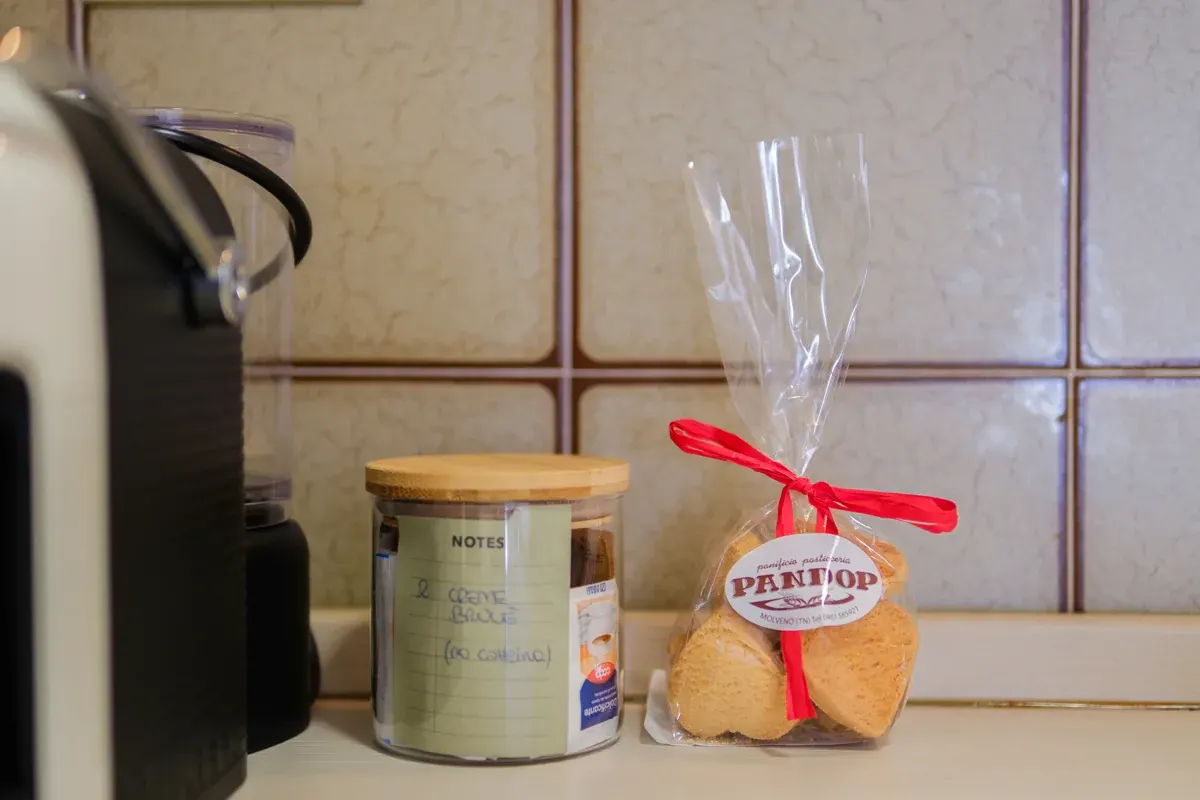 A cup of coffee and the welcome capsules on a table at the Residenza